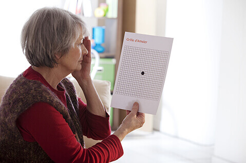 Woman using amsler grid to check for macular conditions